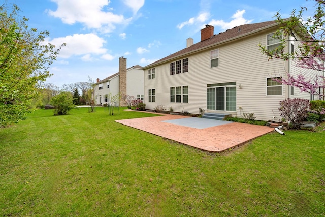 405 Lela Ln, Bartlett, IL 60103 - back of house featuring a patio, a yard, and a chimney