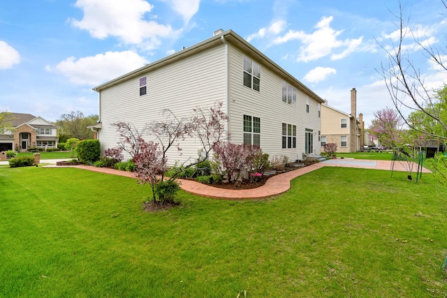 405 Lela Ln, Bartlett, IL 60103 - view of home's exterior with a lawn and a chimney