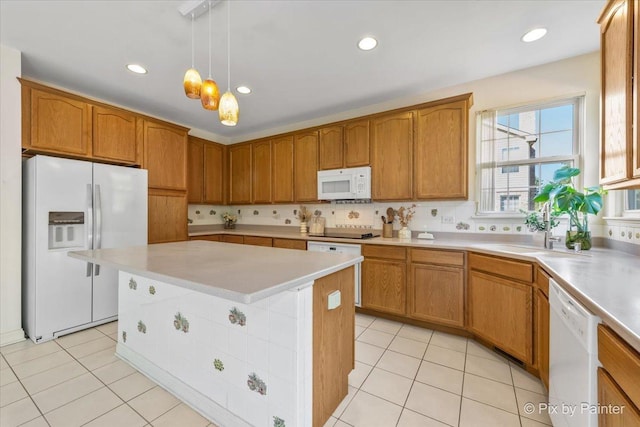 405 Lela Ln, Bartlett, IL 60103 - kitchen featuring white appliances, a sink, brown cabinets, light countertops, and recessed lighting