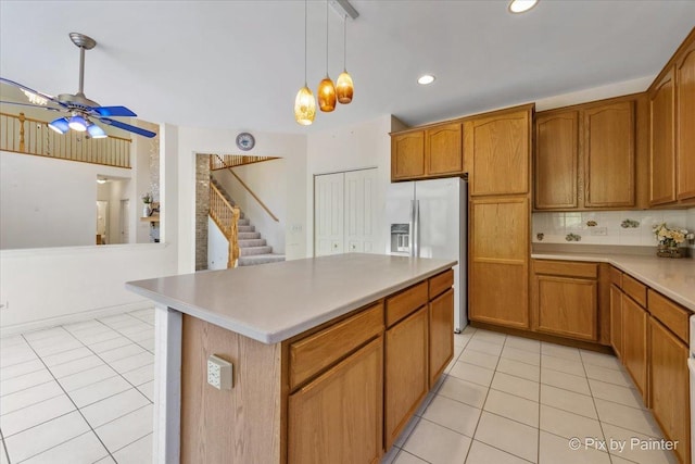 405 Lela Ln, Bartlett, IL 60103 - kitchen with fridge with ice dispenser, light tile patterned floors, a ceiling fan, brown cabinetry, and recessed lighting