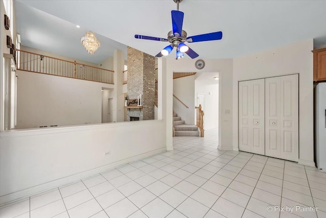 405 Lela Ln, Bartlett, IL 60103 - unfurnished living room featuring ceiling fan, stairway, a fireplace, light tile patterned flooring, and baseboards