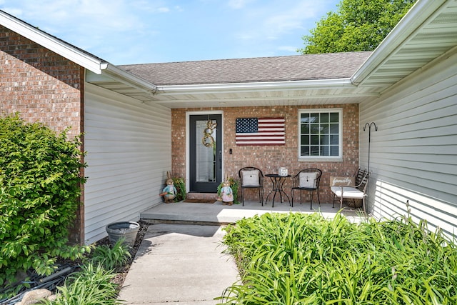2588 Big Bluestem Rd, Morris, IL 60450 - doorway to property with roof with shingles, brick siding, and a porch
