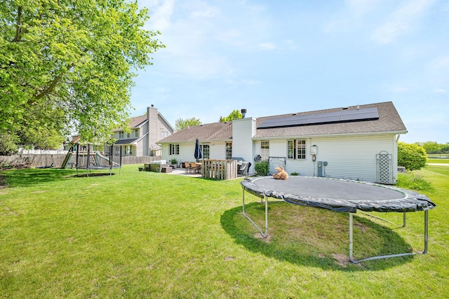 2588 Big Bluestem Rd, Morris, IL 60450 - rear view of house featuring a trampoline, a playground, solar panels, outdoor lounge area, and a patio area