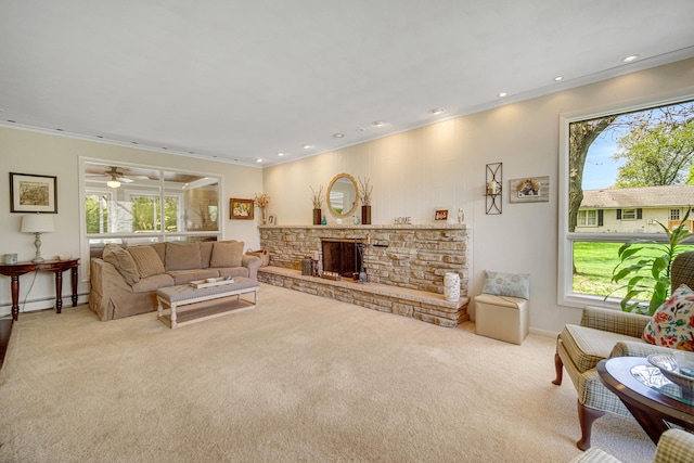 living room featuring plenty of natural light, carpet flooring, a fireplace, crown molding, and recessed lighting