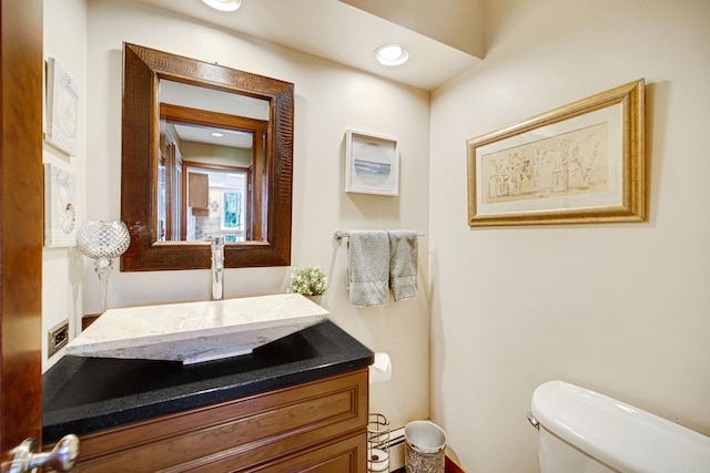 bathroom featuring toilet and vanity