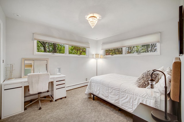 carpeted bedroom with a baseboard heating unit and an office area