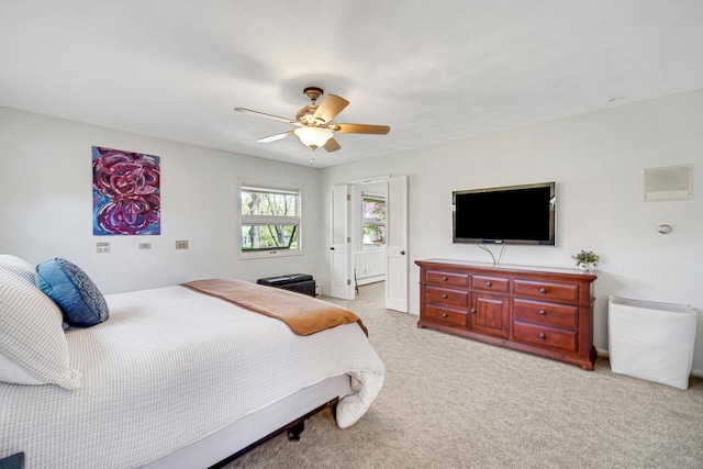 bedroom featuring light carpet, ceiling fan, and baseboards