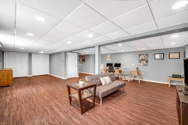 living area featuring wood finished floors, baseboards, and recessed lighting