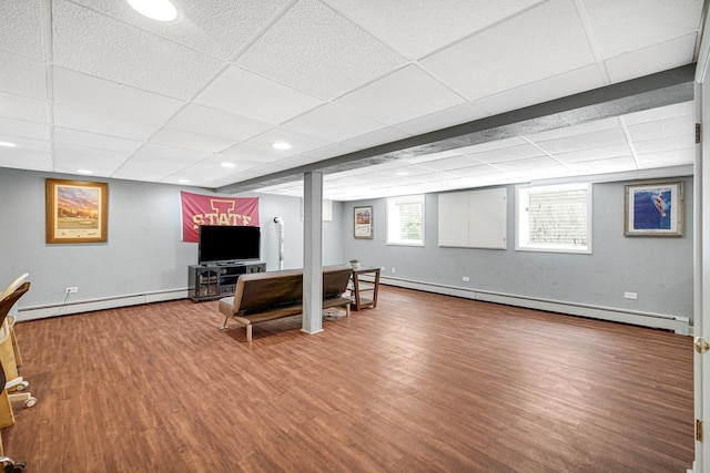 living room with a baseboard heating unit, wood finished floors, a drop ceiling, baseboards, and recessed lighting
