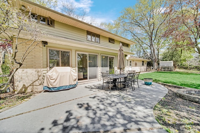 view of patio / terrace with a fire pit and outdoor dining area
