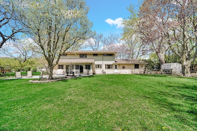 rear view of property with a yard and a patio area
