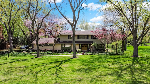 back of property with a lawn