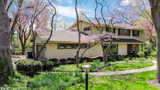 view of front of property with brick siding and a front yard