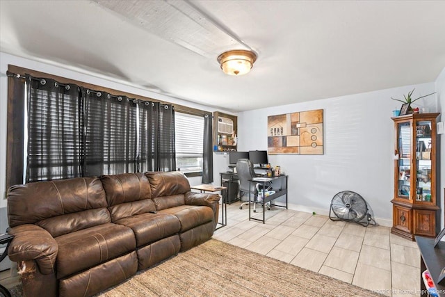 living room featuring an office area and baseboards