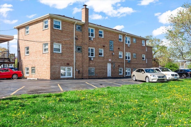 view of building exterior with uncovered parking