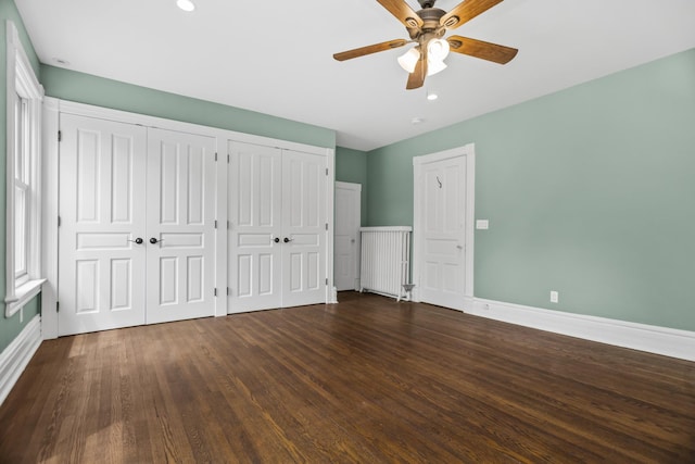 827 Madison St, Evanston, IL 60202 - unfurnished bedroom with multiple closets, baseboards, dark wood finished floors, recessed lighting, and ceiling fan