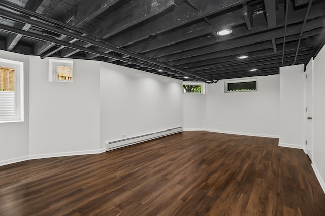 827 Madison St, Evanston, IL 60202 - basement with a baseboard heating unit, wood finished floors, and baseboards