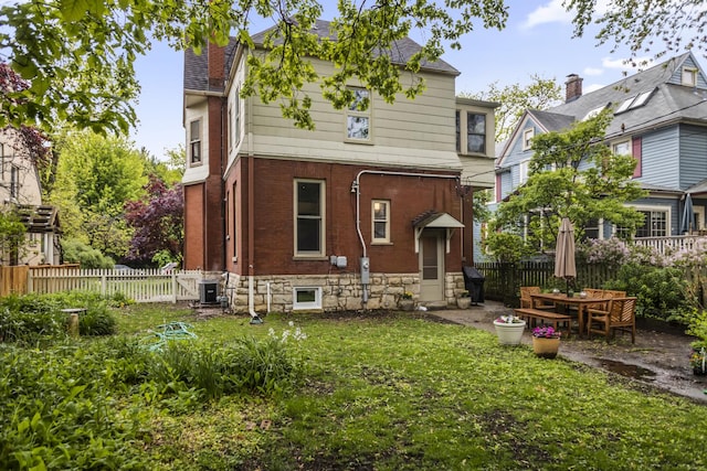 827 Madison St, Evanston, IL 60202 - rear view of house featuring a chimney, central AC, brick siding, and a patio area