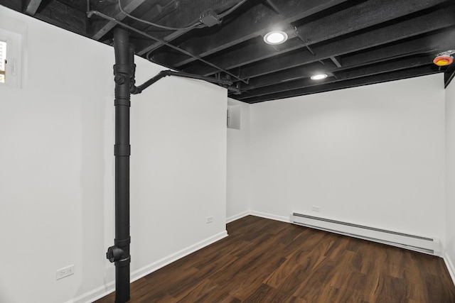827 Madison St, Evanston, IL 60202 - finished below grade area with baseboard heating, wood finished floors, and baseboards