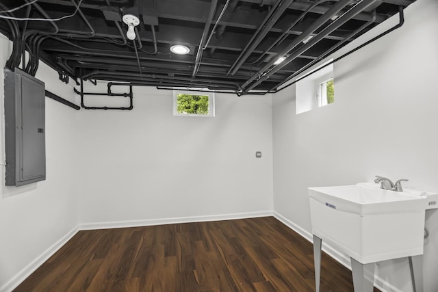 827 Madison St, Evanston, IL 60202 - below grade area featuring electric panel, plenty of natural light, dark wood-style floors, and baseboards