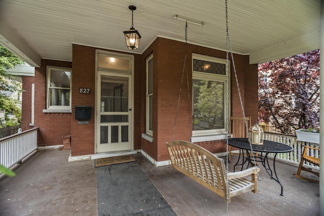 827 Madison St, Evanston, IL 60202 - view of exterior entry featuring brick siding and a porch