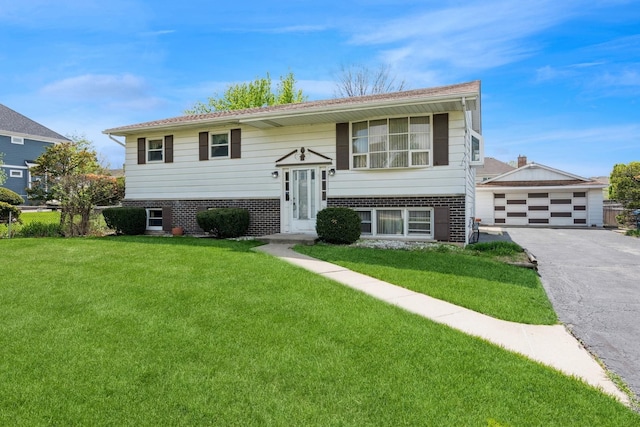 bi-level home with brick siding, a front yard, and a garage