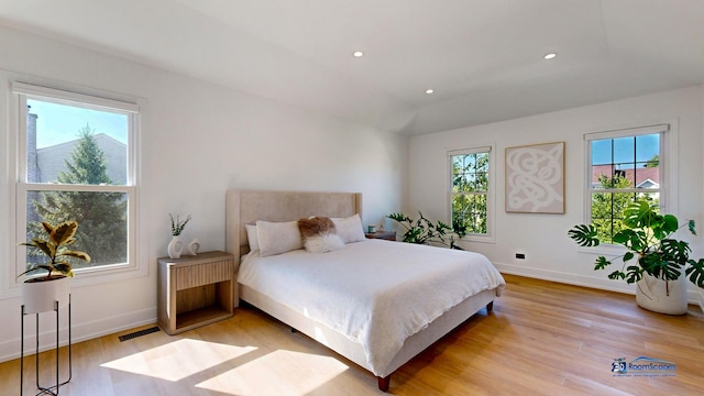 bedroom with light wood finished floors, baseboards, and recessed lighting