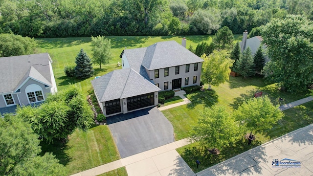 aerial view of property and surrounding area featuring a heavily wooded area