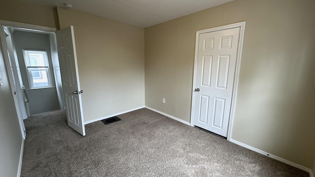 306 S Liberty St, Elgin, IL 60120 - unfurnished bedroom with dark carpet and baseboards