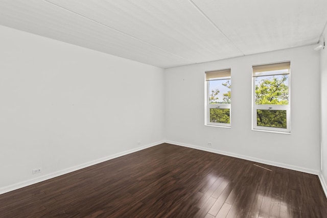 2020 St Johns Ave Unit 507, Highland Park, IL 60035 - spare room featuring baseboards and dark wood-type flooring