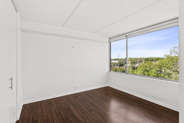 2020 St Johns Ave Unit 507, Highland Park, IL 60035 - spare room with baseboards and dark wood-style flooring