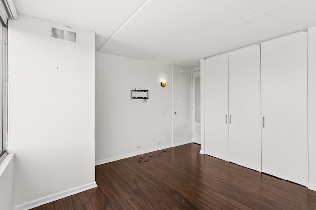 2020 St Johns Ave Unit 507, Highland Park, IL 60035 - unfurnished bedroom with wood finished floors, baseboards, and a closet