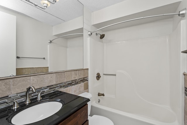 2020 St Johns Ave Unit 507, Highland Park, IL 60035 - bathroom featuring washtub / shower combination, toilet, decorative backsplash, vanity, and a textured ceiling