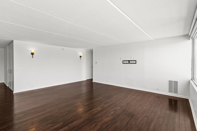 2020 St Johns Ave Unit 507, Highland Park, IL 60035 - spare room with dark wood-style floors, baseboards, and a textured ceiling