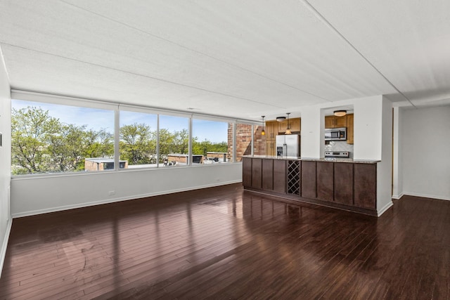 2020 St Johns Ave Unit 507, Highland Park, IL 60035 - unfurnished living room featuring dark wood-style floors and baseboards
