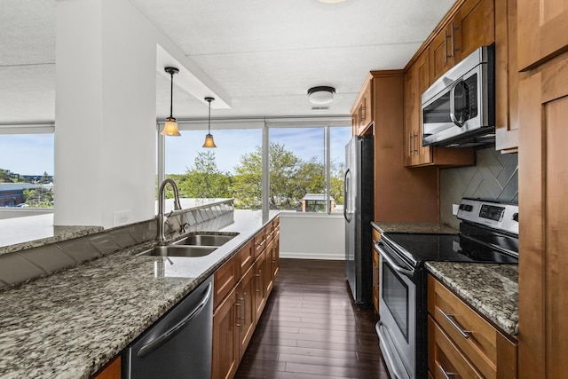 2020 St Johns Ave Unit 507, Highland Park, IL 60035 - kitchen with appliances with stainless steel finishes, a sink, dark wood-type flooring, and dark stone counters