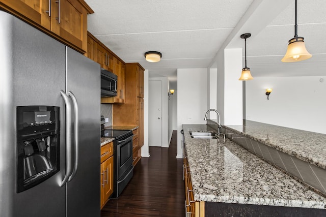 2020 St Johns Ave Unit 507, Highland Park, IL 60035 - kitchen with stainless steel appliances, a sink, brown cabinets, and dark wood finished floors