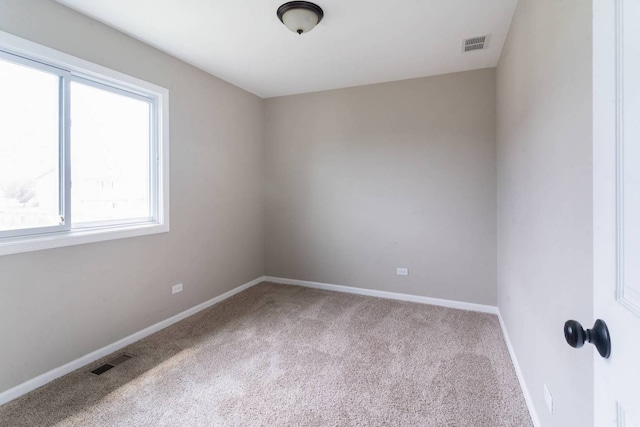 carpeted spare room with baseboards