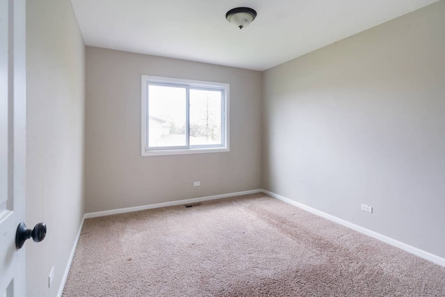 carpeted spare room with baseboards