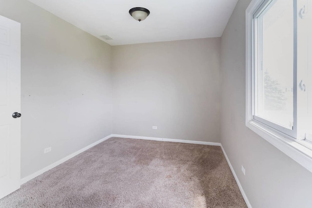unfurnished room with carpet flooring, plenty of natural light, and baseboards