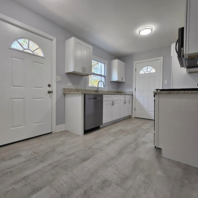 kitchen featuring dishwasher, white cabinets, light stone countertops, a sink, and black microwave
