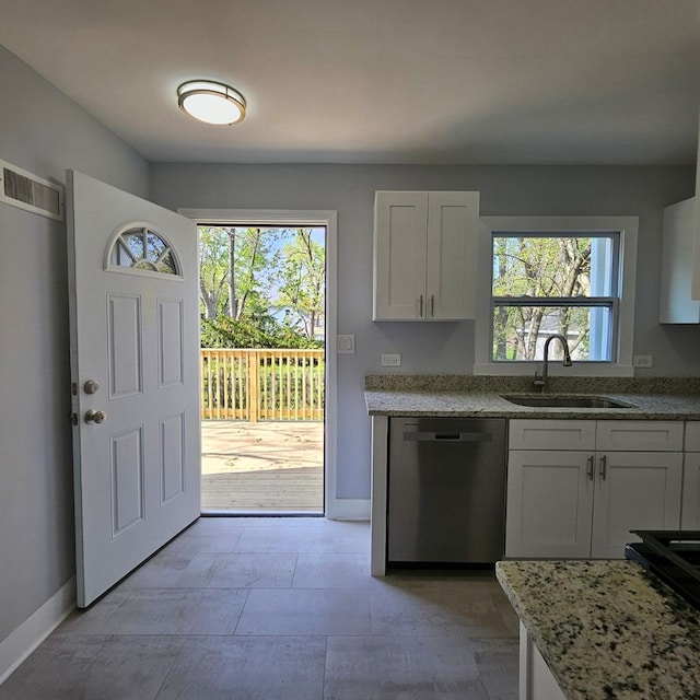 kitchen with dishwasher, a sink, baseboards, and light stone counters