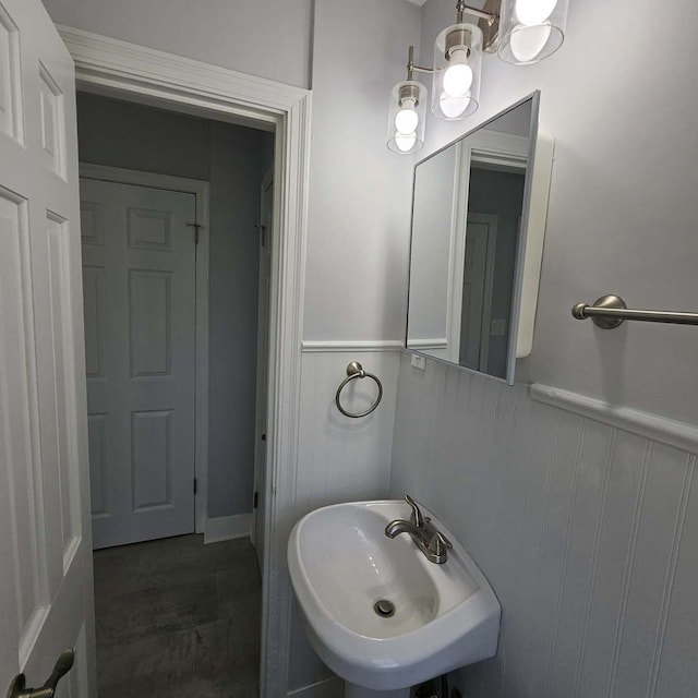 bathroom with a sink and a wainscoted wall