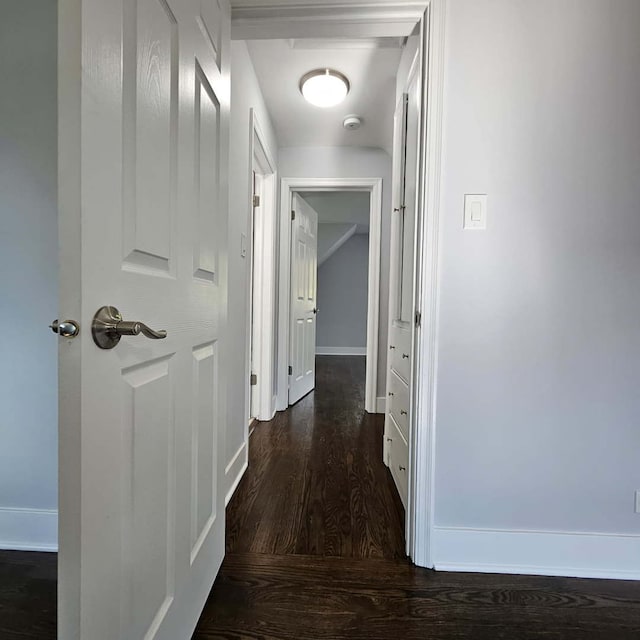 hallway with wood finished floors and baseboards