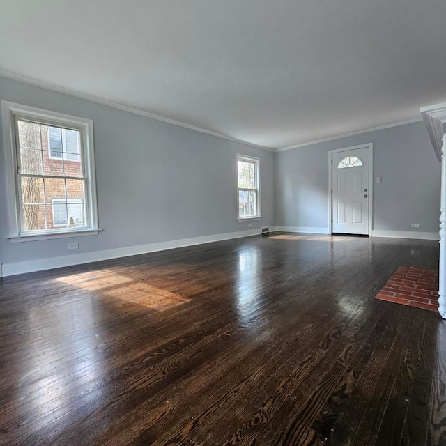 unfurnished living room featuring crown molding, dark wood-style floors, and baseboards