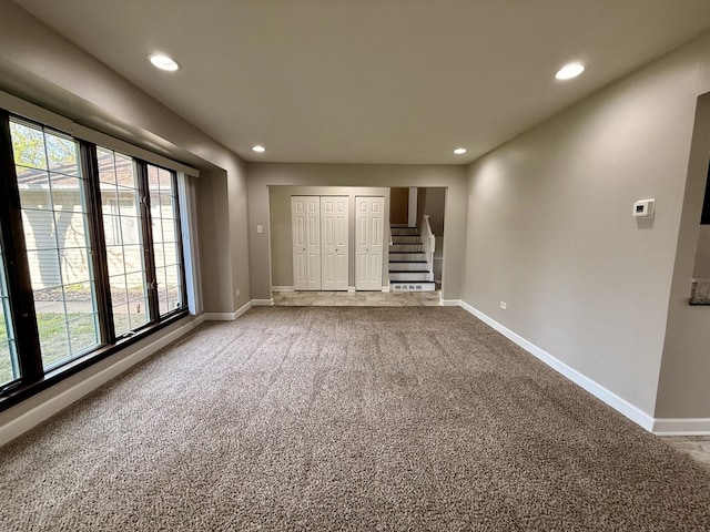 unfurnished bedroom with carpet, baseboards, recessed lighting, and multiple windows