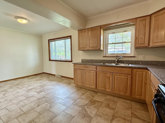 kitchen featuring a sink, stove, dark countertops, ornamental molding, and baseboards