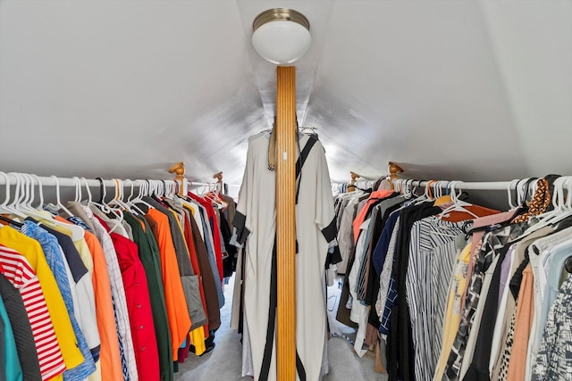 walk in closet with lofted ceiling and carpet floors