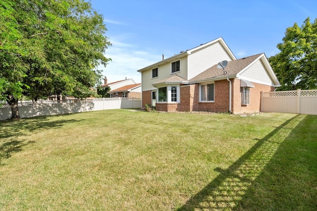 rear view of property featuring brick siding