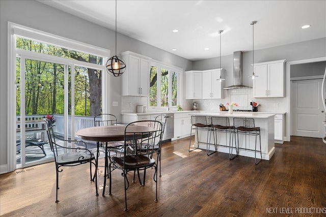 dining space featuring healthy amount of natural light, recessed lighting, and dark wood-style floors